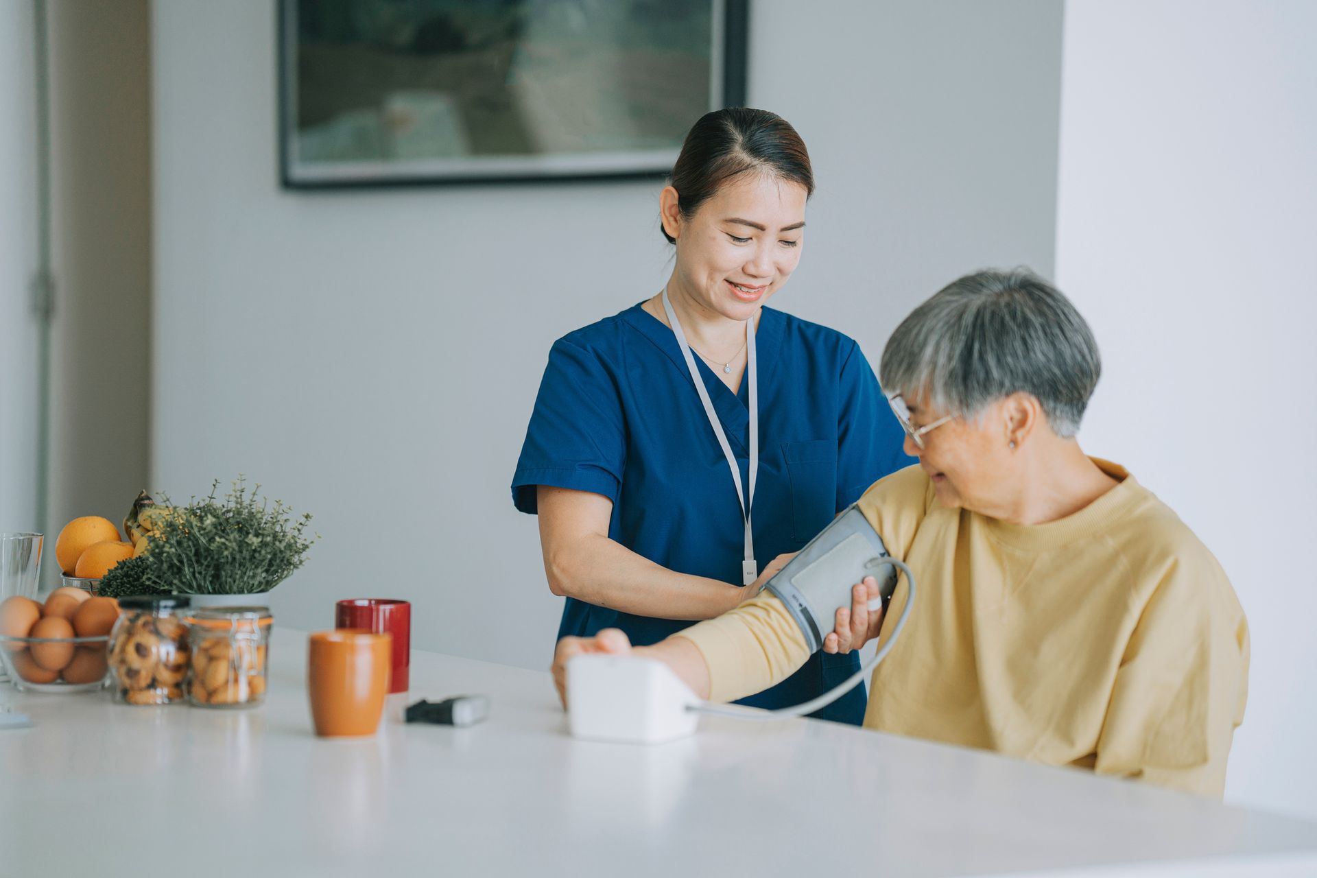 A nurse is checking the blood pressure of the patient.