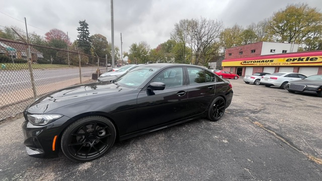 Black car parked in front of auto repair shop | Autohaus Merkle