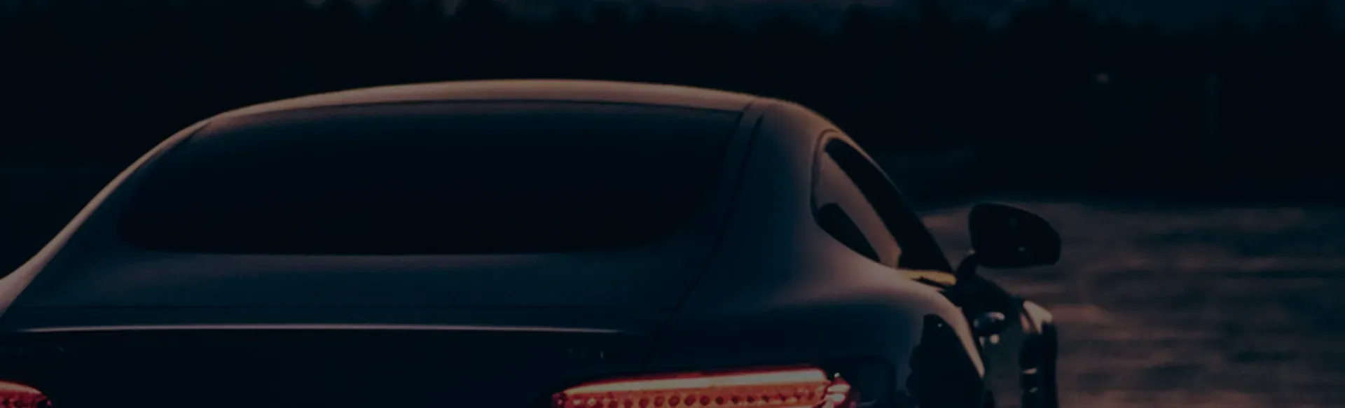 Back view of blue car driving in background | Autohaus Merkle