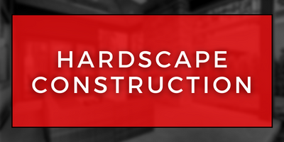 Red sign with white text reading “HARDSCAPE CONSTRUCTION”