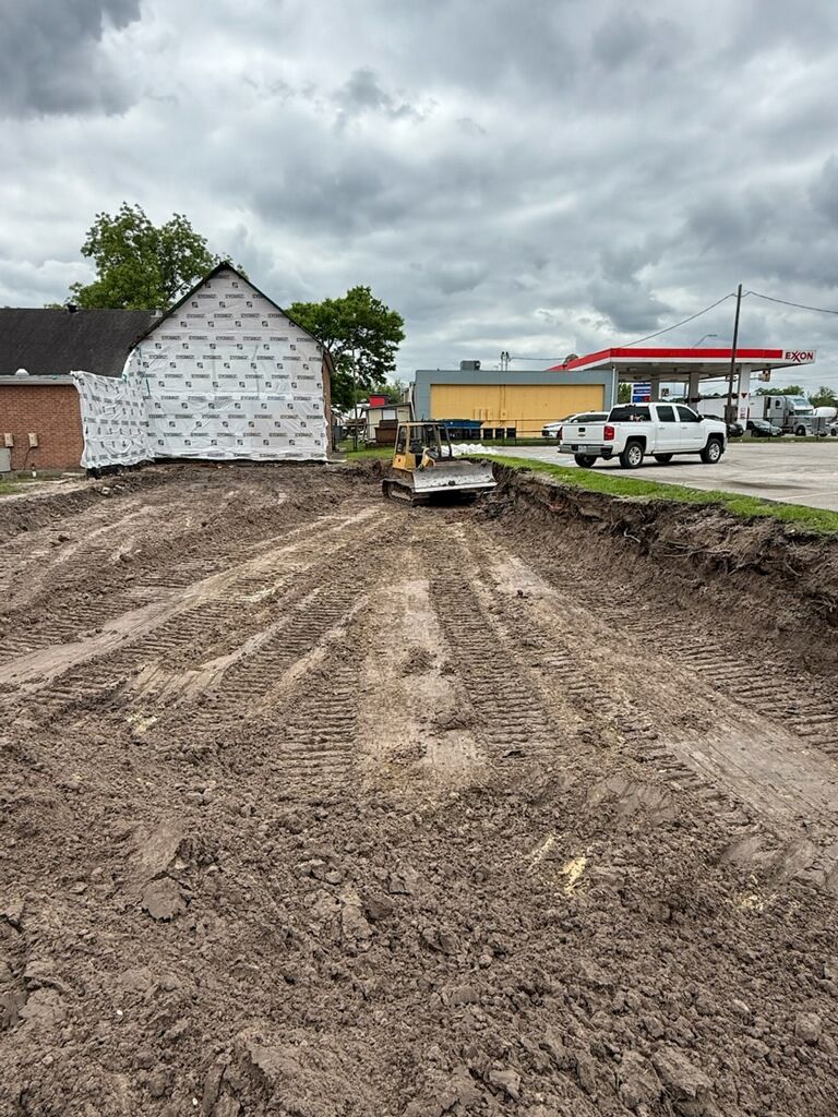 A construction site with a gas station in the background.