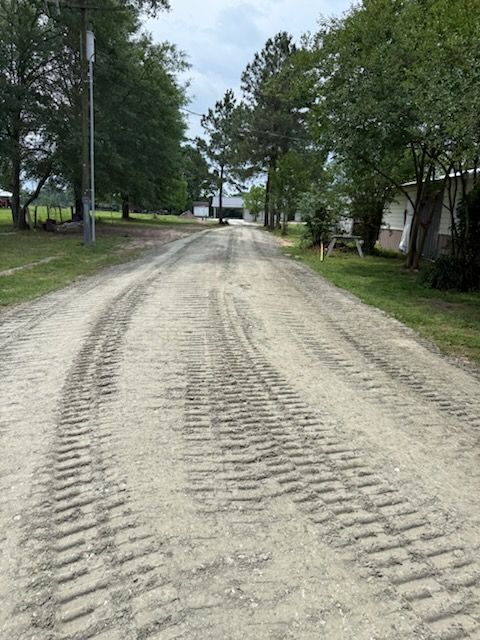 A dirt road with a lot of tire tracks on it