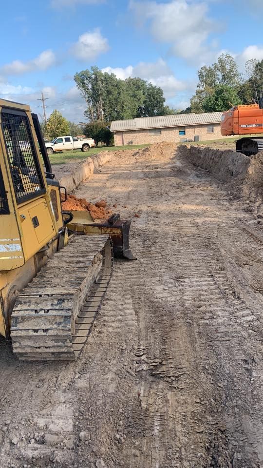 A bulldozer is sitting on top of a dirt road.