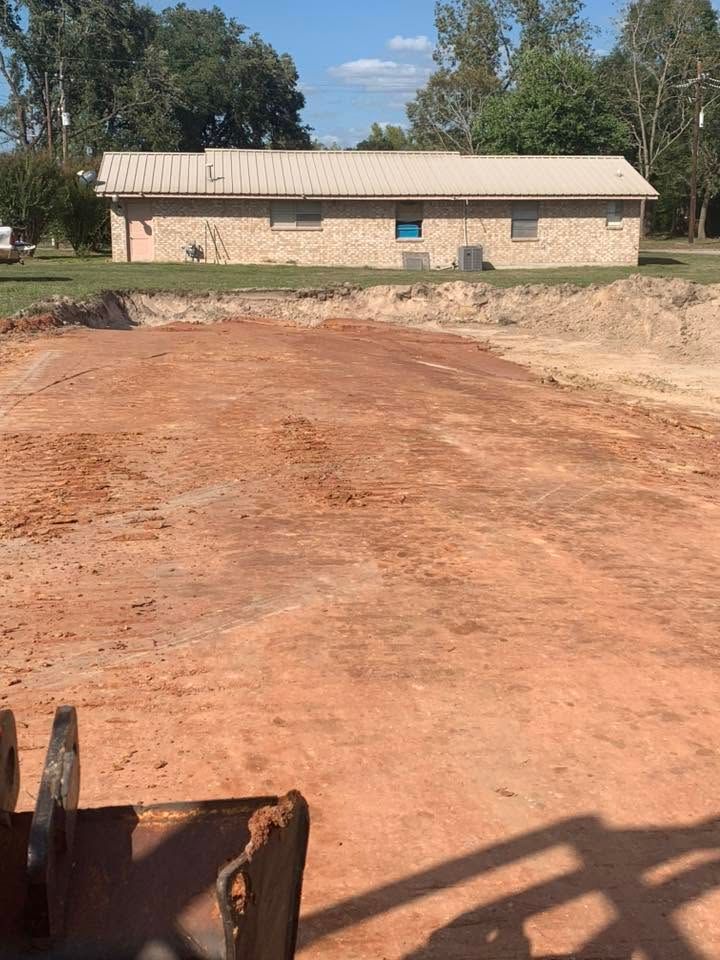 A bulldozer is moving dirt in front of a house.