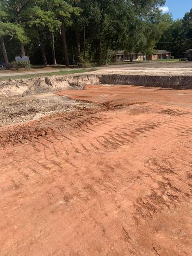 A large pile of dirt is sitting on top of a dirt field.