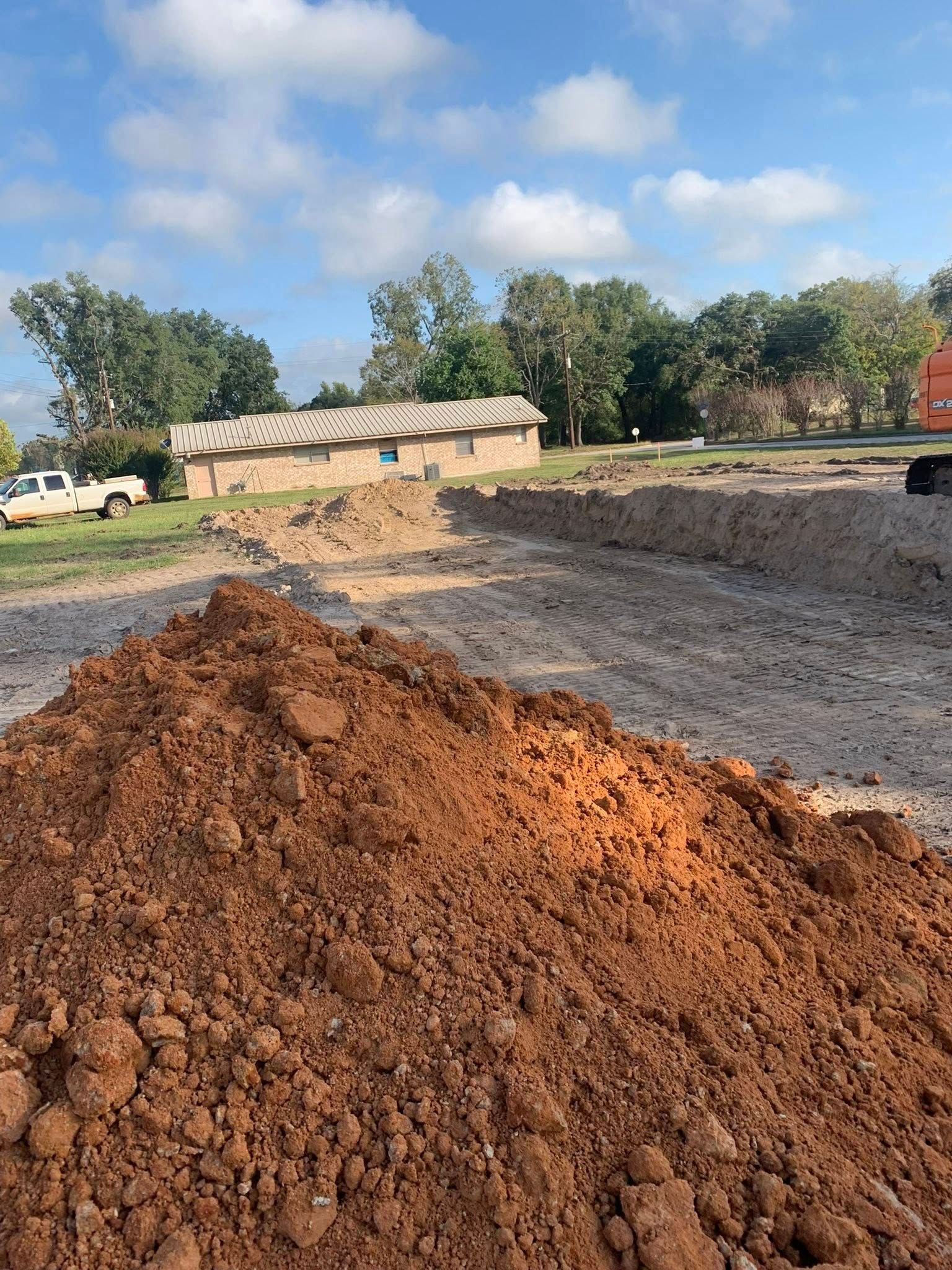 A pile of dirt is sitting in the middle of a dirt field.