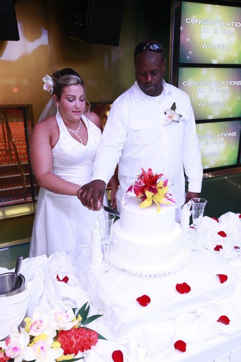 A bride and groom are cutting their wedding cake
