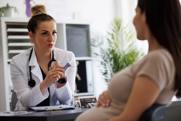 An Ob/Gyn consulting with a pregnant patient, representing obstetric care in Richmond, VA, at West E