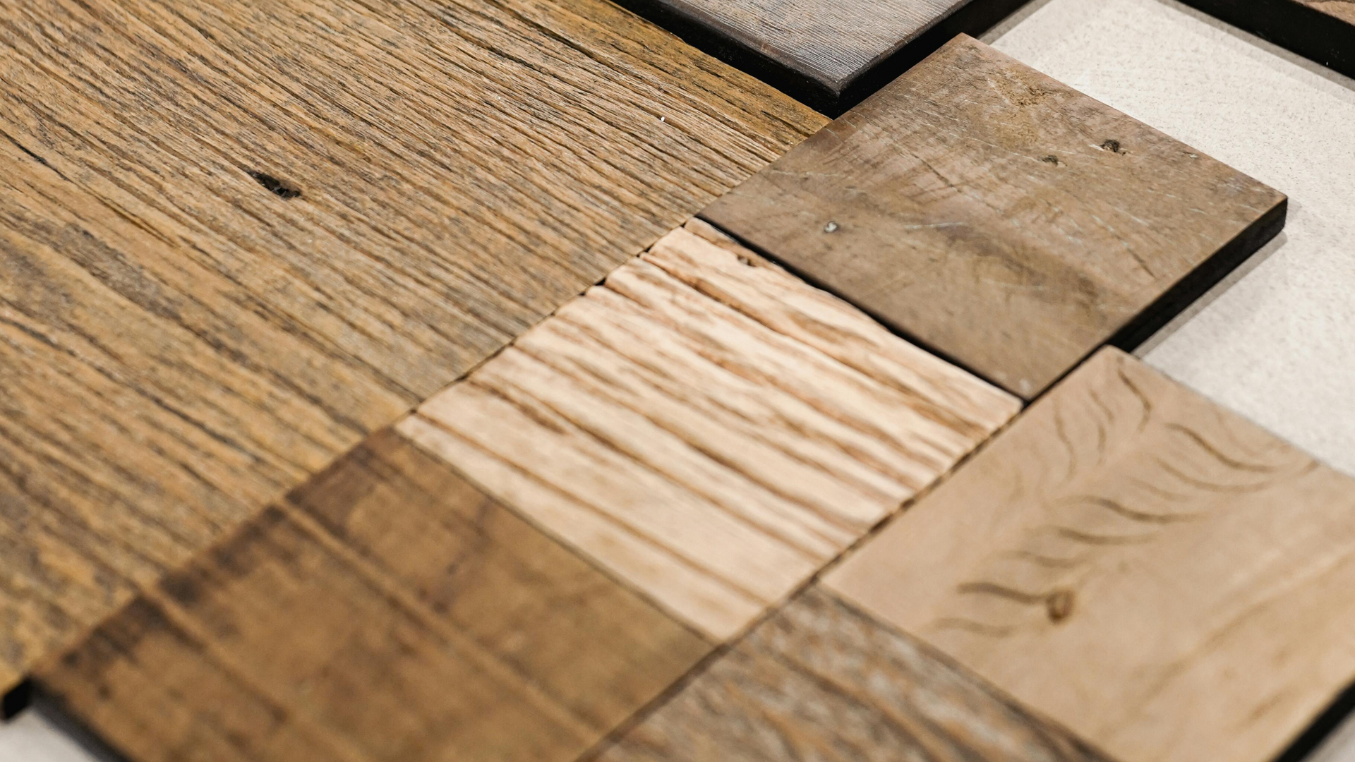 A bunch of different types of wood are sitting on top of each other on a table.