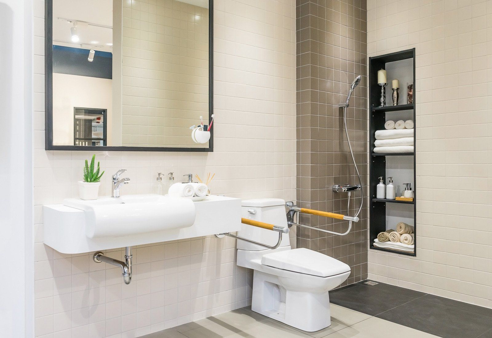 a bathroom with a toilet , sink , mirror and shower . tile installer and shower pan man