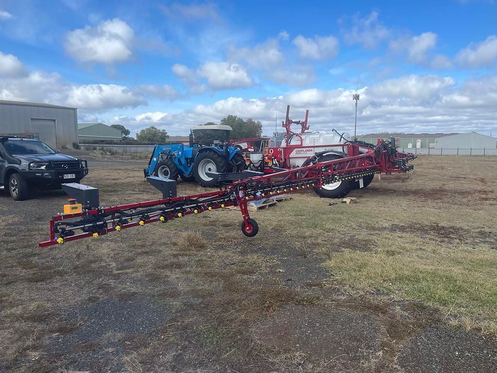A tractor and a trailer are parked in a field.