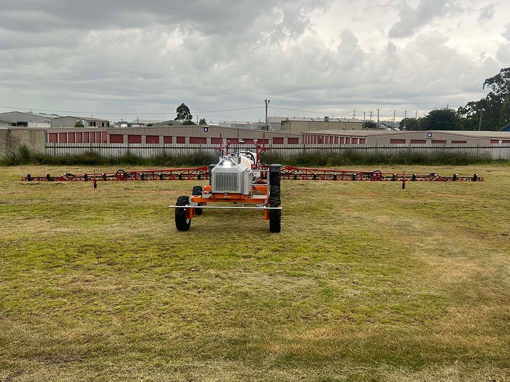 A tractor is sitting in the middle of a grassy field.