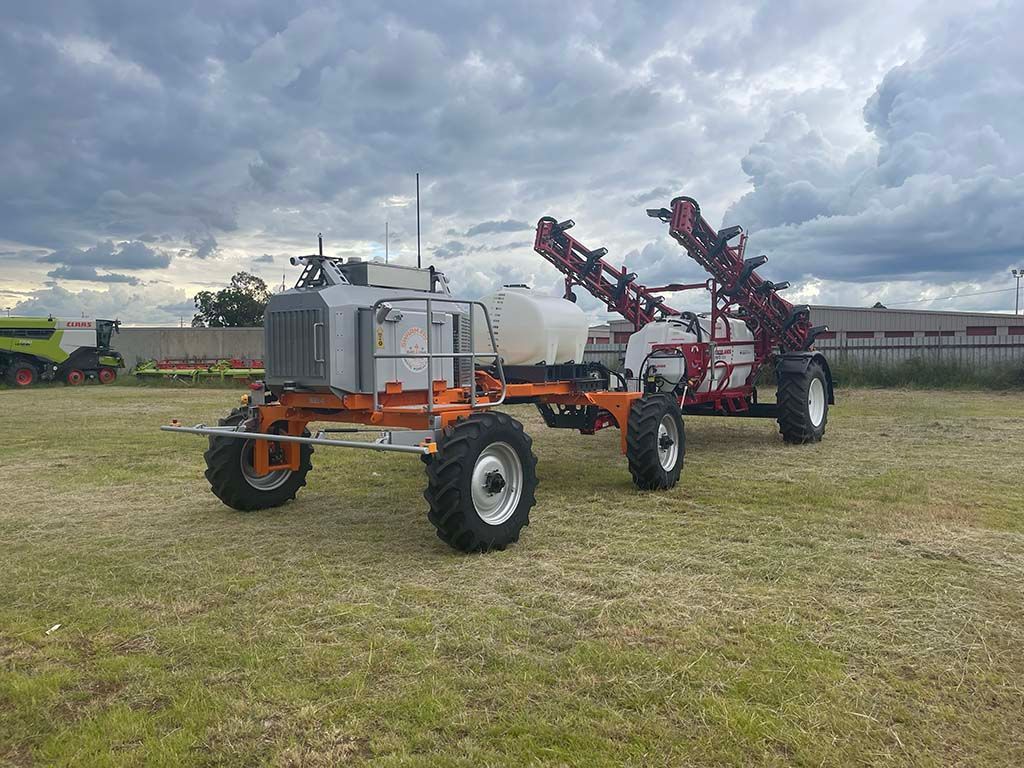 Two tractors are parked next to each other in a field.