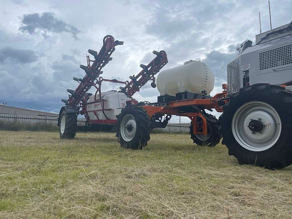 Two tractors are parked next to each other in a field.
