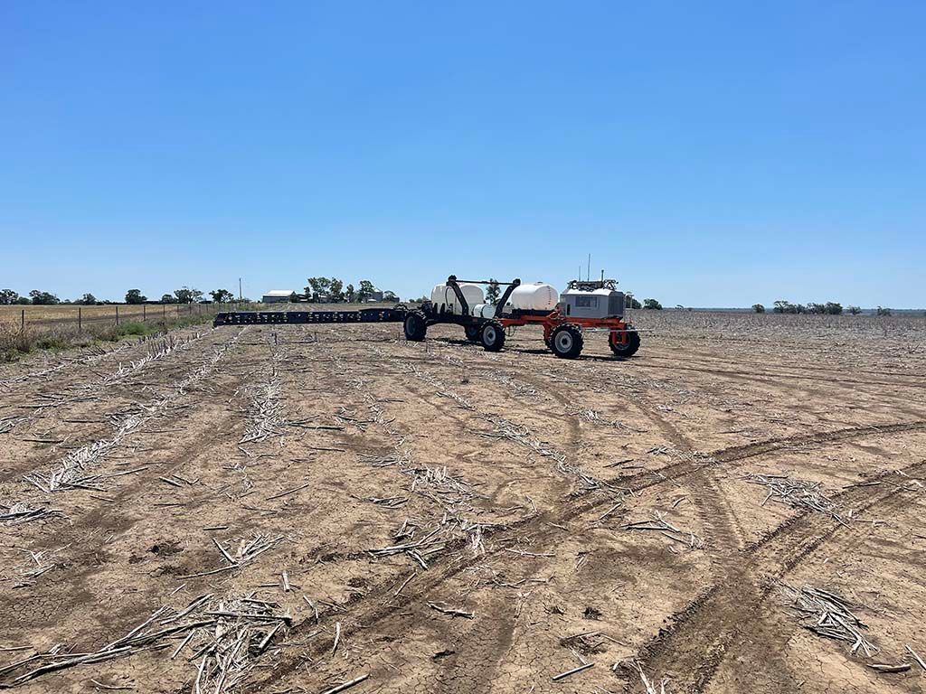 A tractor is sitting in the middle of a dirt field.