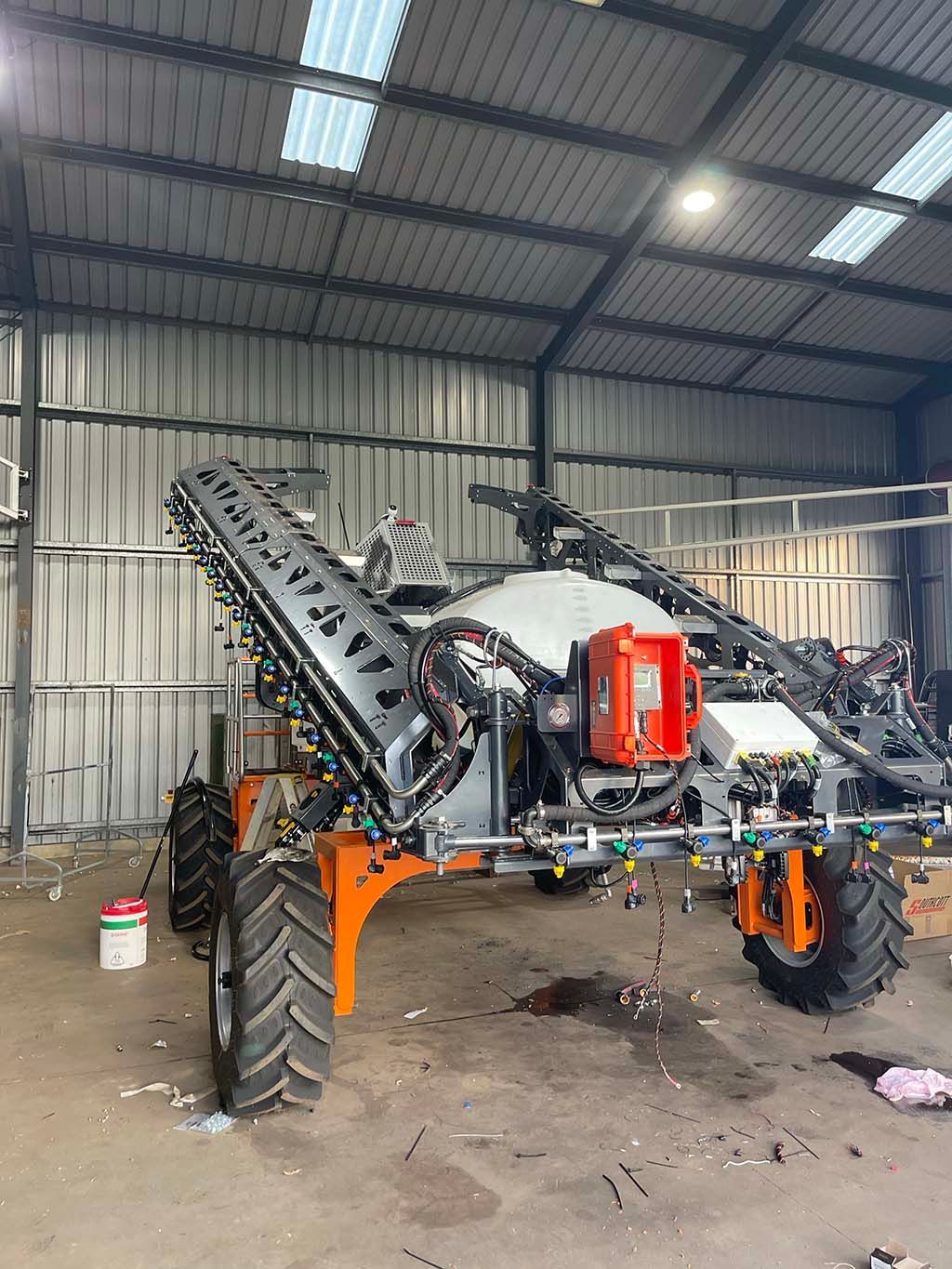 A large machine is sitting in a warehouse.