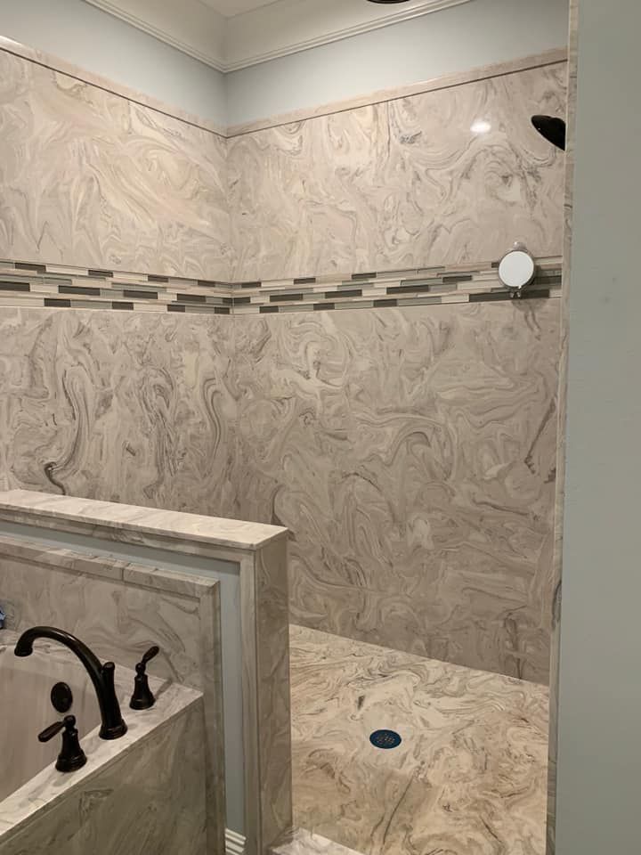 A bathroom with a walk in shower and a bathtub.