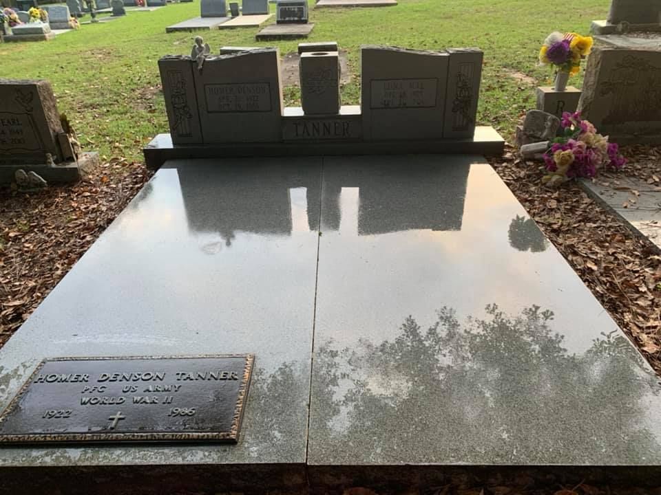 A grave in a cemetery with flowers on it