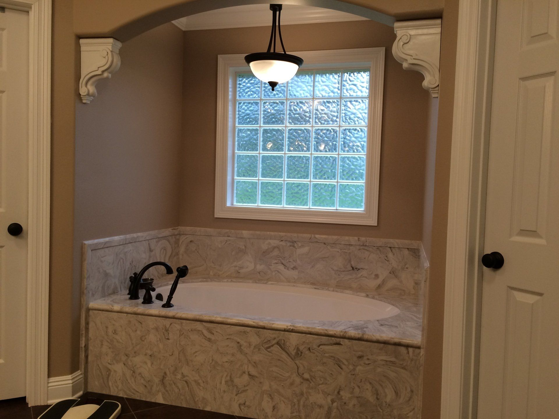 A bathroom with a bathtub and a window