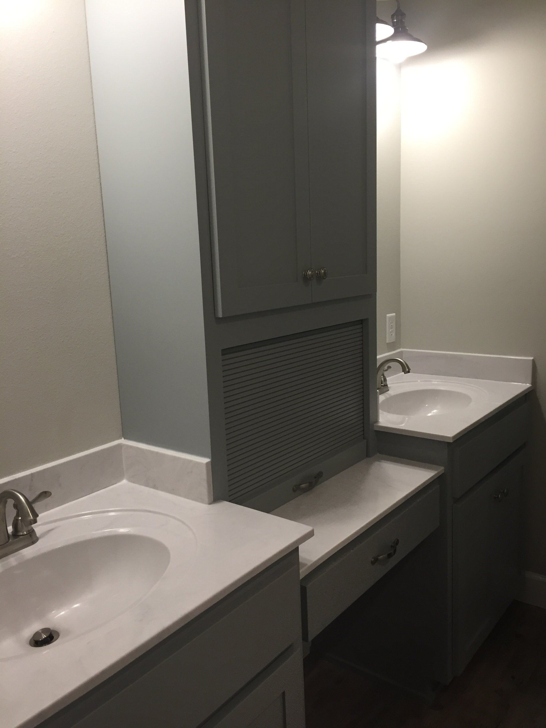 A bathroom with two sinks and a mirror.