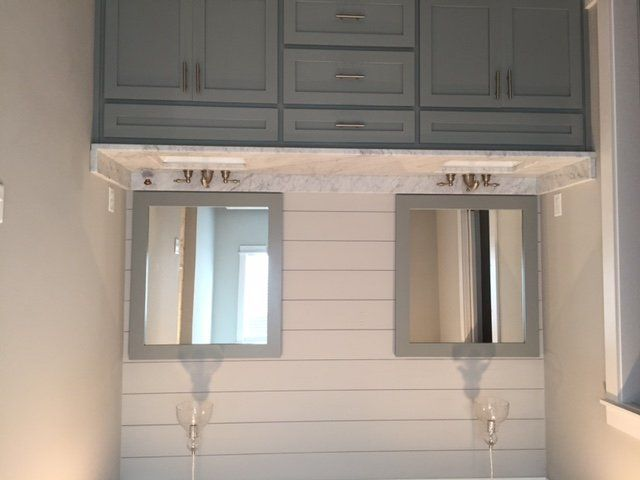 A bathroom with two sinks and two mirrors.