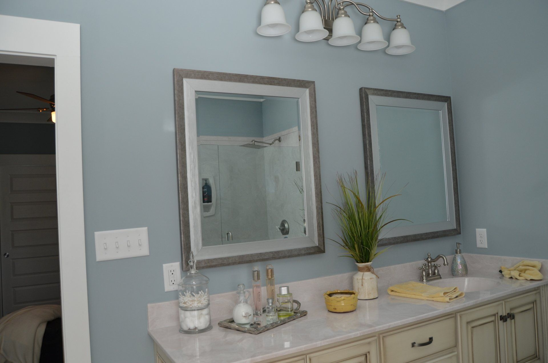 A bathroom with two sinks and two mirrors.