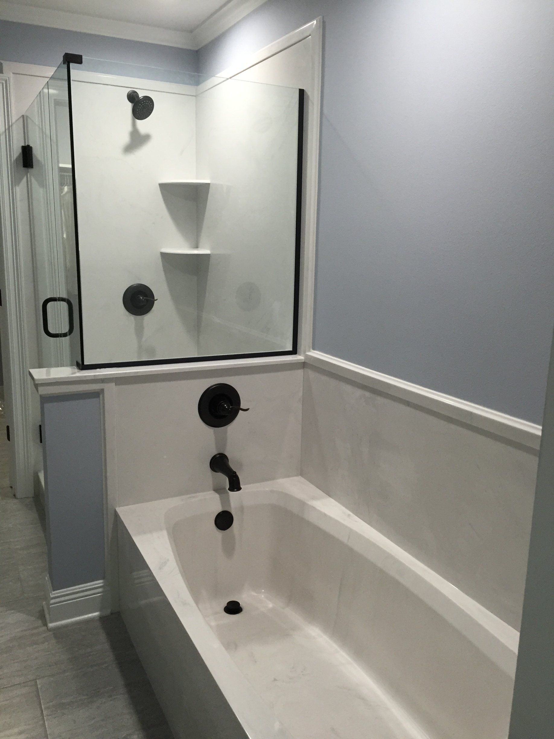 A bathroom with a bathtub and a shower.