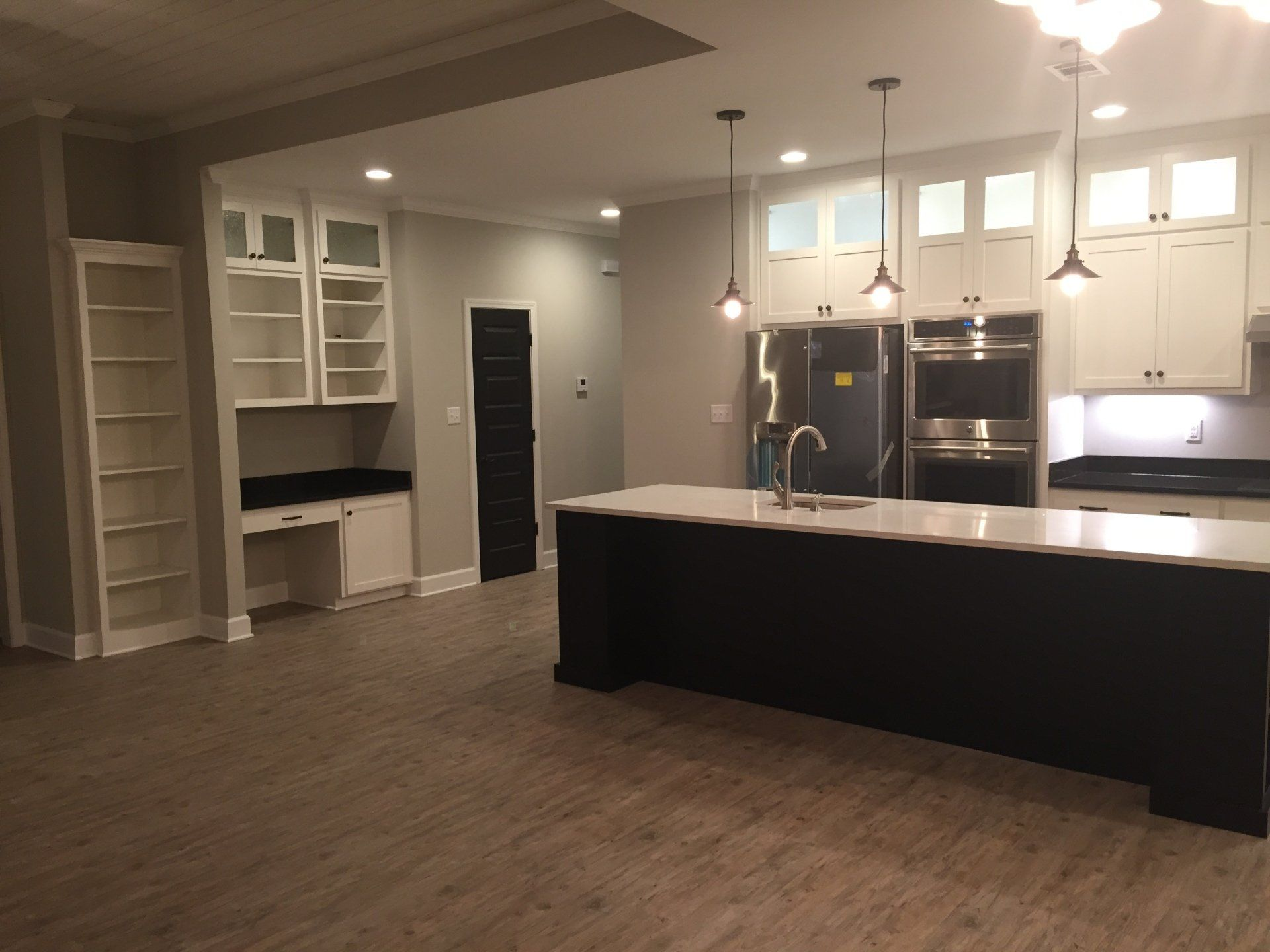 A kitchen with a large island and stainless steel appliances