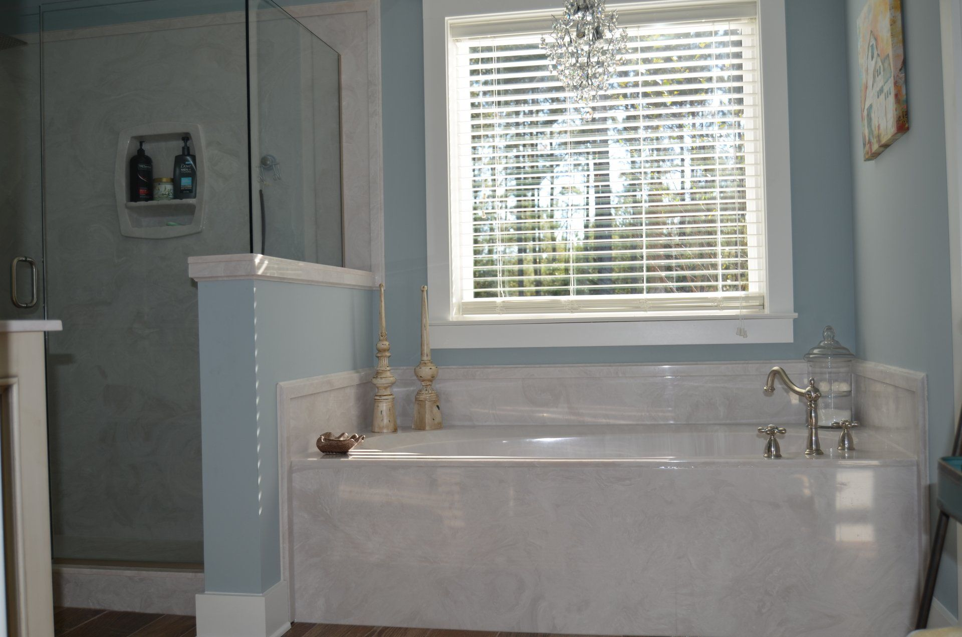 A bathroom with a tub and a window with blinds