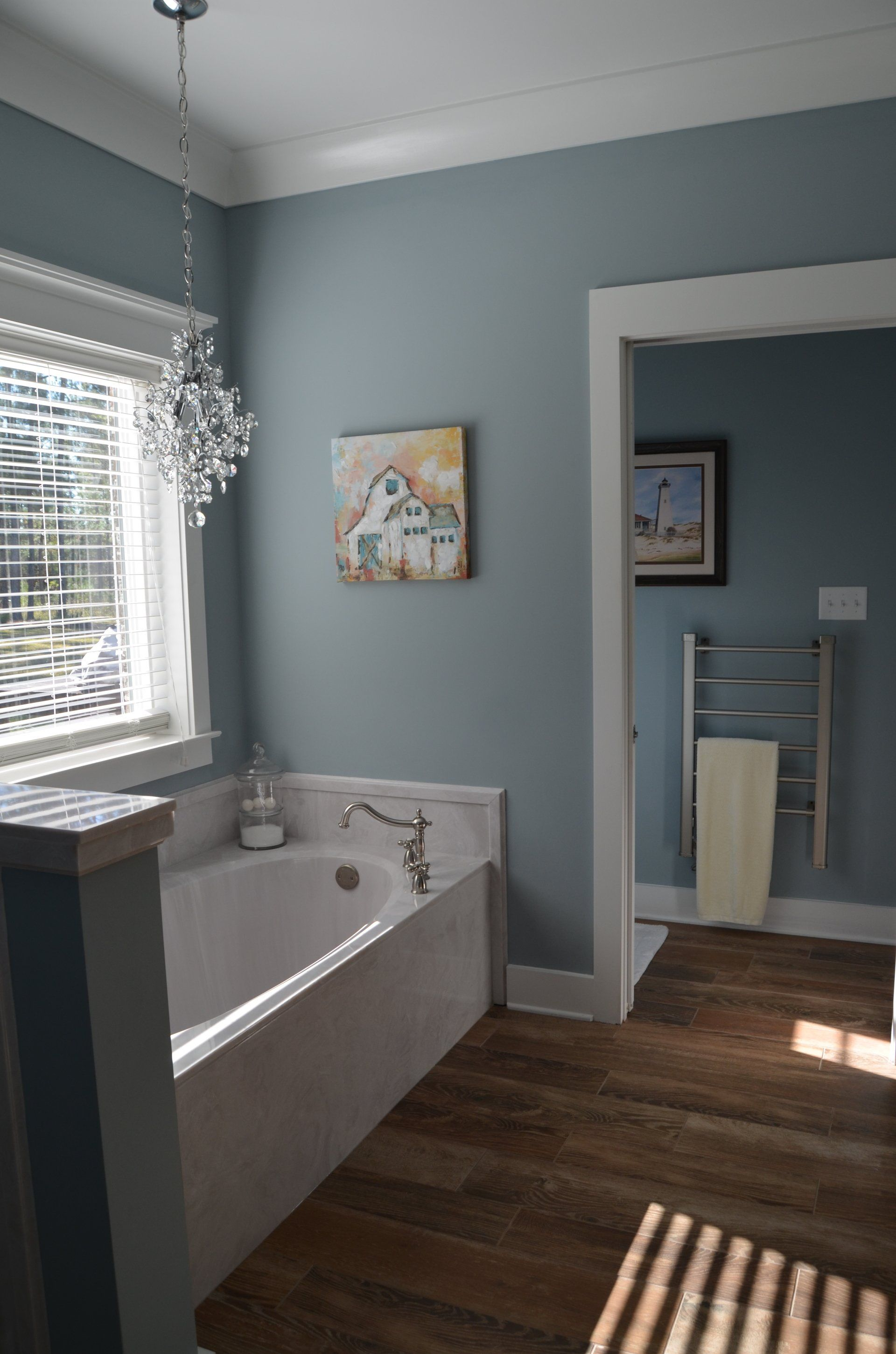 A bathroom with a bathtub and a window.