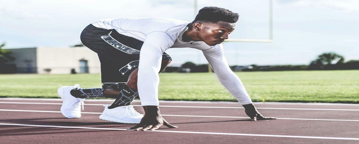 A man is getting ready to run on a track.