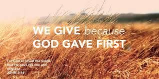 A picture of a field of tall grass with the words `` we give because god gave first ''.