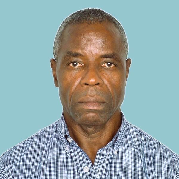 A man in a plaid shirt is looking at the camera.