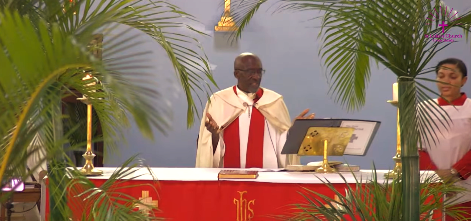 Priest reading on Palm Sunday.