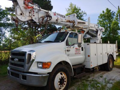 A white utility truck with a crane on top of it