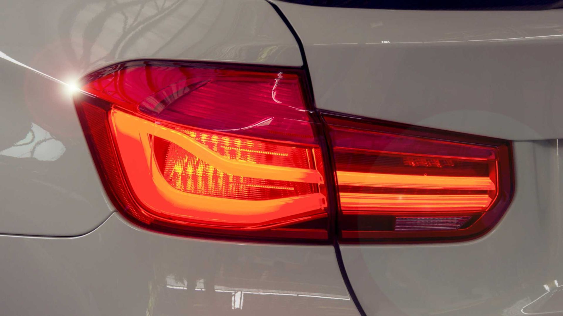 A close up of a white car 's tail light.