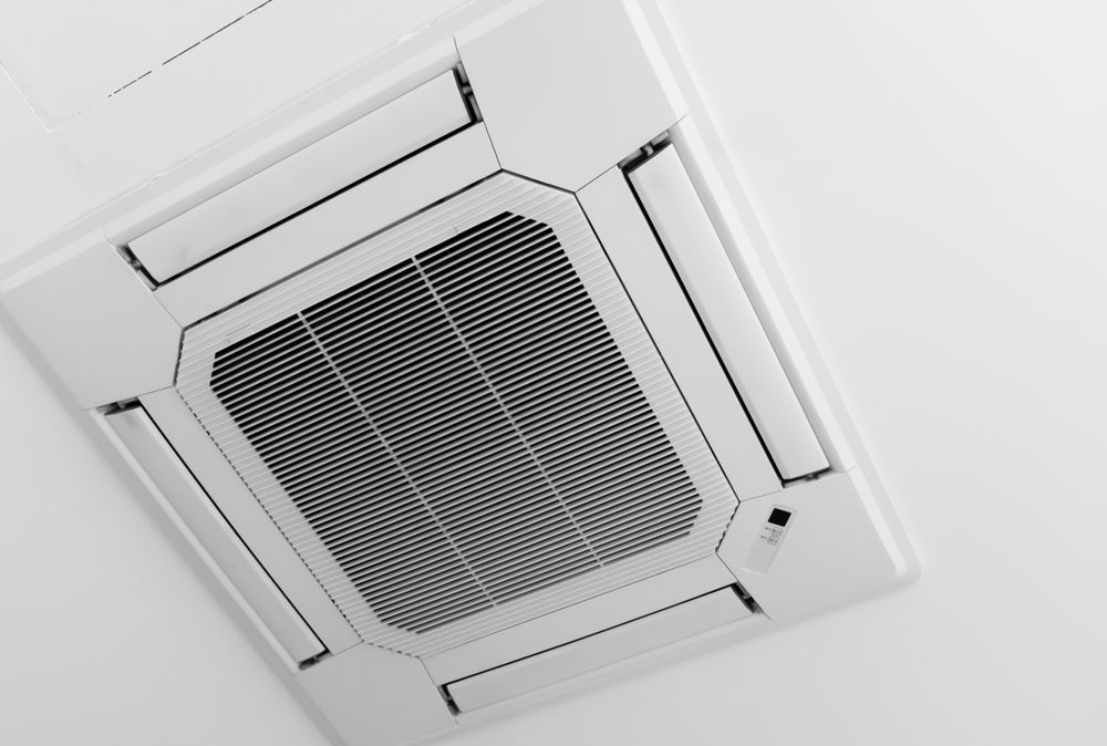 Ceiling-mounted air conditioning unit with a rectangular, grid-like vent. White with angled edges. — Cooling Plus Refrigeration & Airconditioning in Ciccone, NT