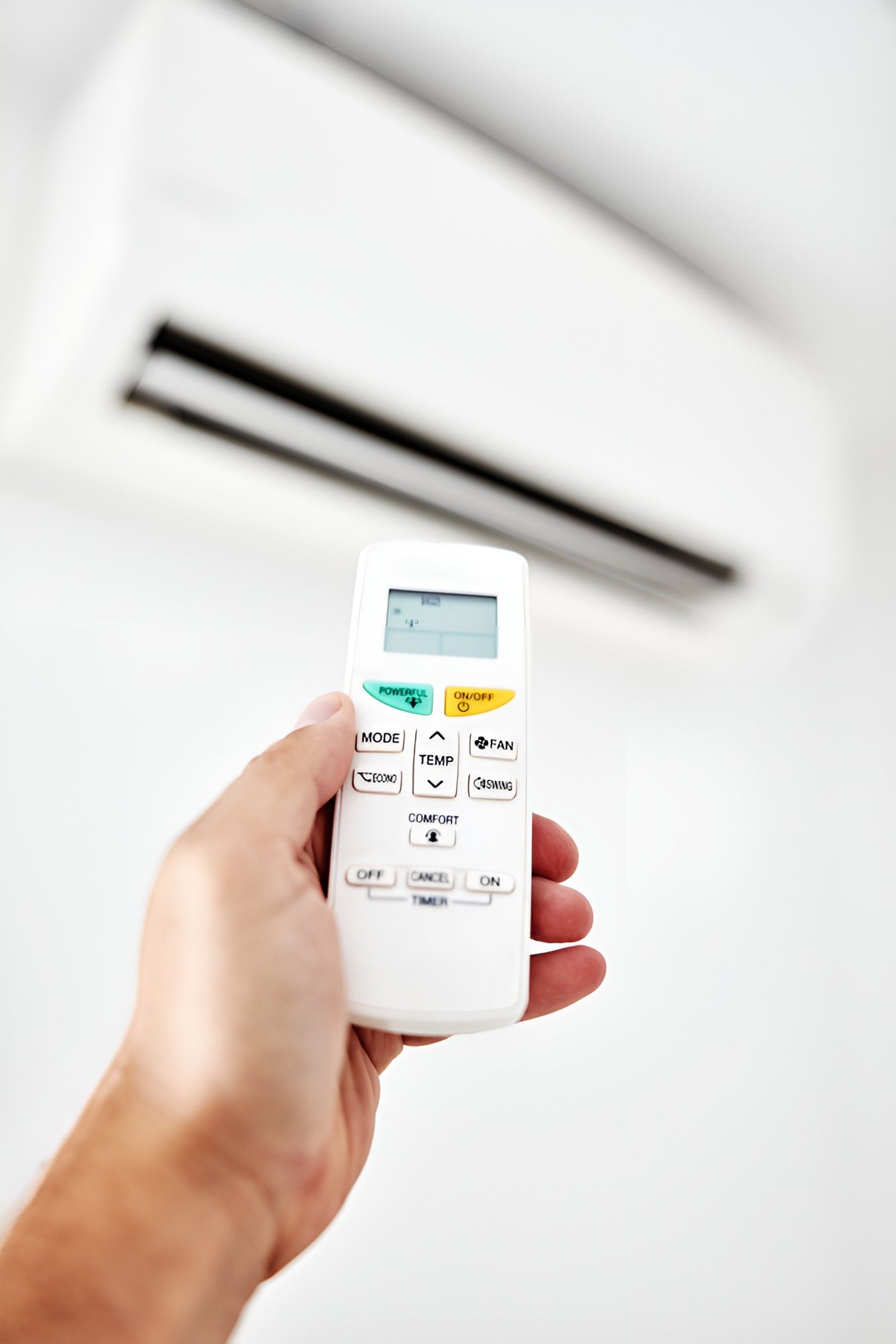 A Person is Holding a Remote Control of an Air Conditioner — Cooling Plus Refrigeration & Airconditioning in Ciccone, NT