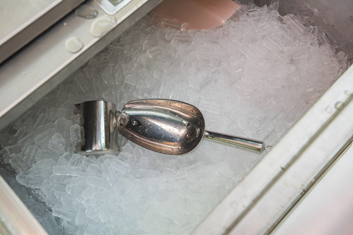 A Scoop of Ice is Sitting in a Container of Ice — Cooling Plus Refrigeration & Airconditioning in Ciccone, NT