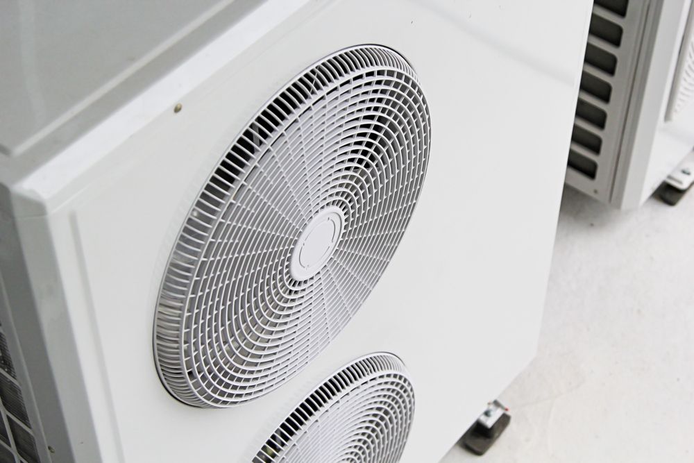 White air conditioning units with fan grilles, outdoors. — Cooling Plus Refrigeration & Airconditioning in Ciccone, NT