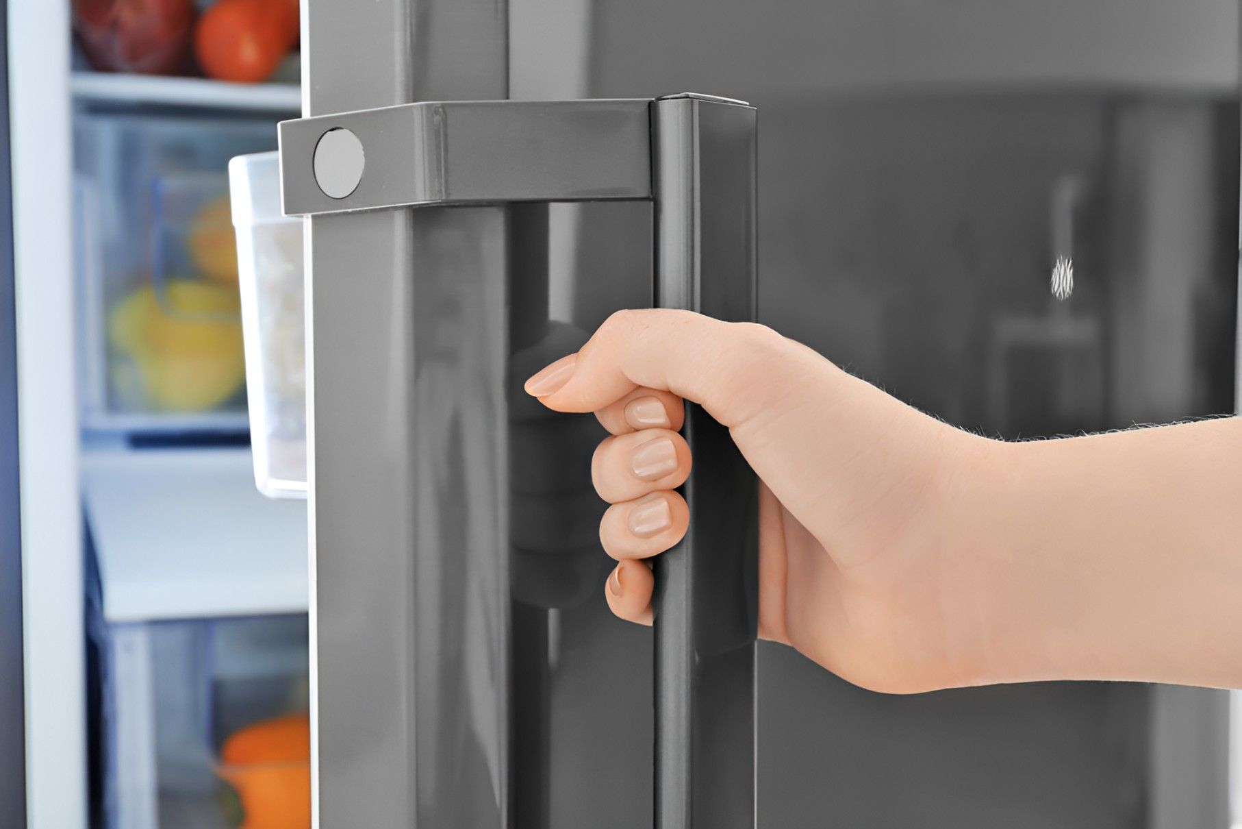 A Person is Opening a Refrigerator Door With Their Hand — Cooling Plus Refrigeration & Airconditioning in Ciccone, NT