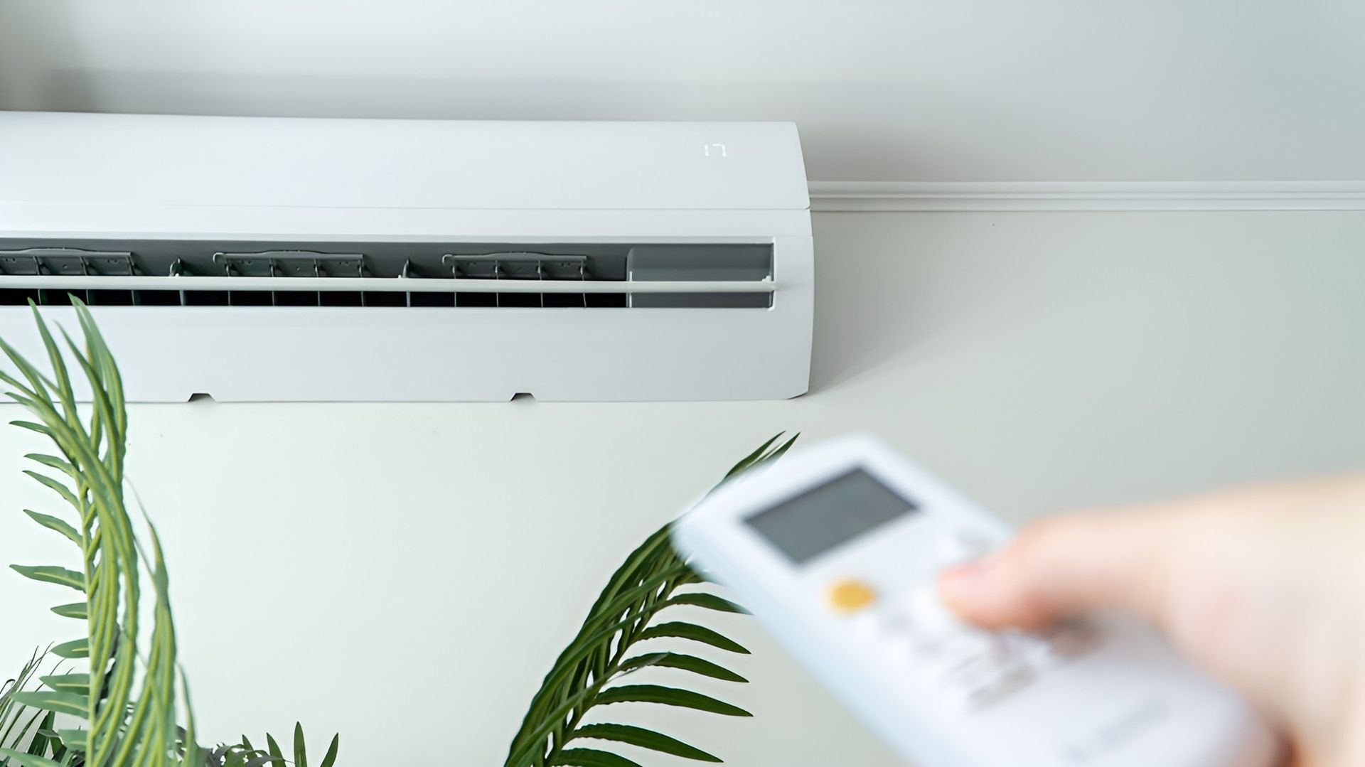 Person is Holding a Remote Control of an Air Conditioner — Cooling Plus Refrigeration & Airconditioning in Ciccone, NT