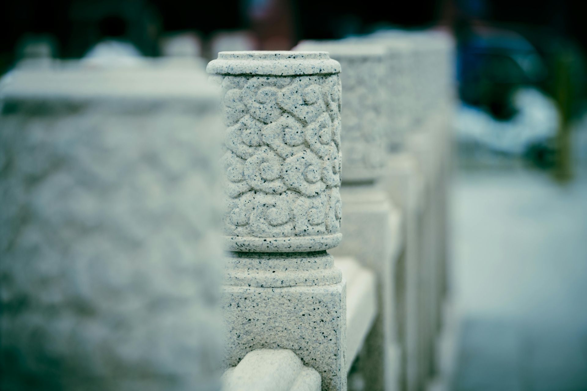 Stone balustrade with ornate floral carvings.