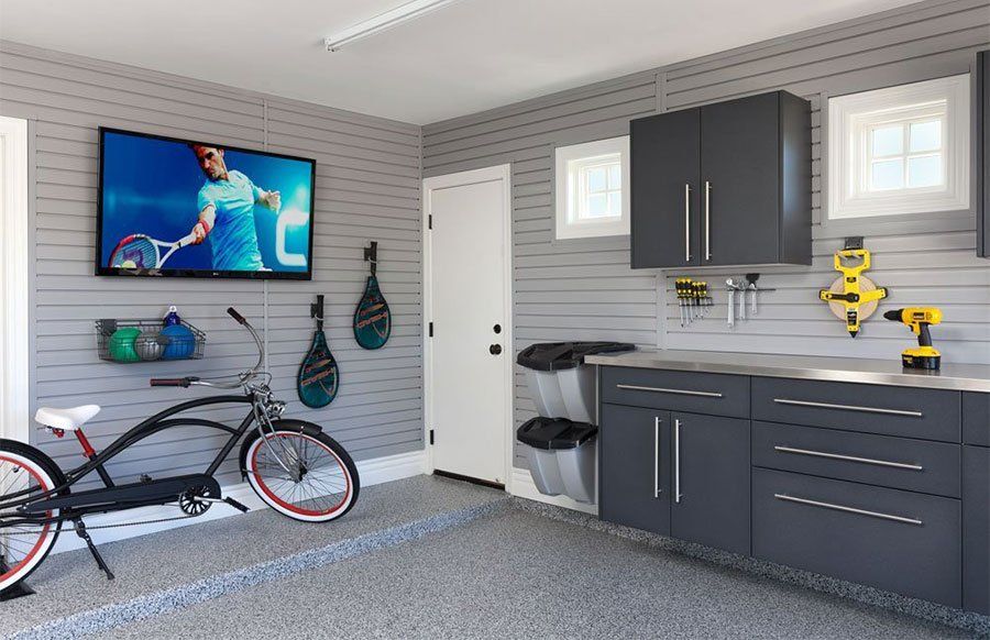 A bicycle is parked in a garage next to a television.