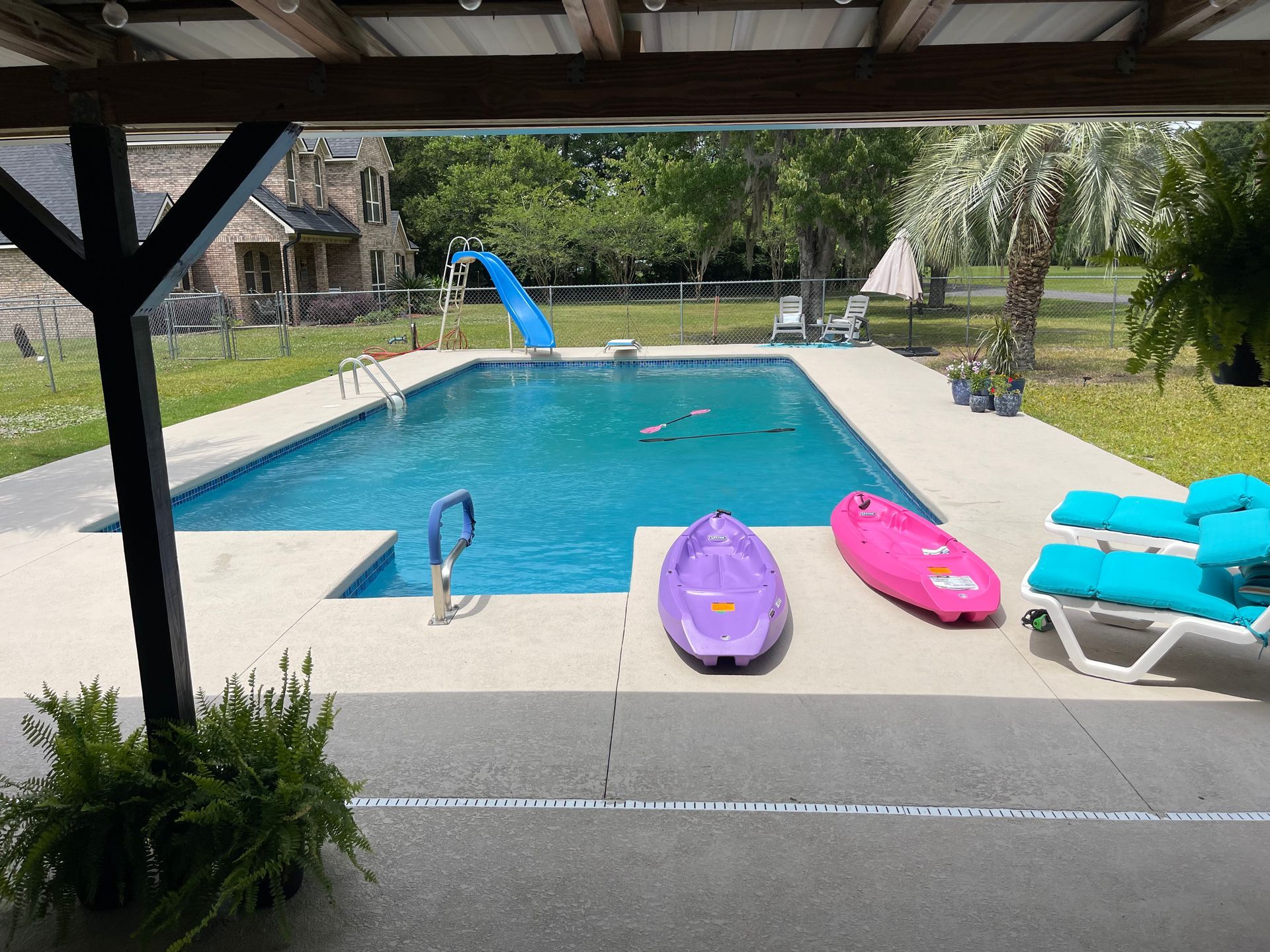A large swimming pool with two kayaks on the side of it