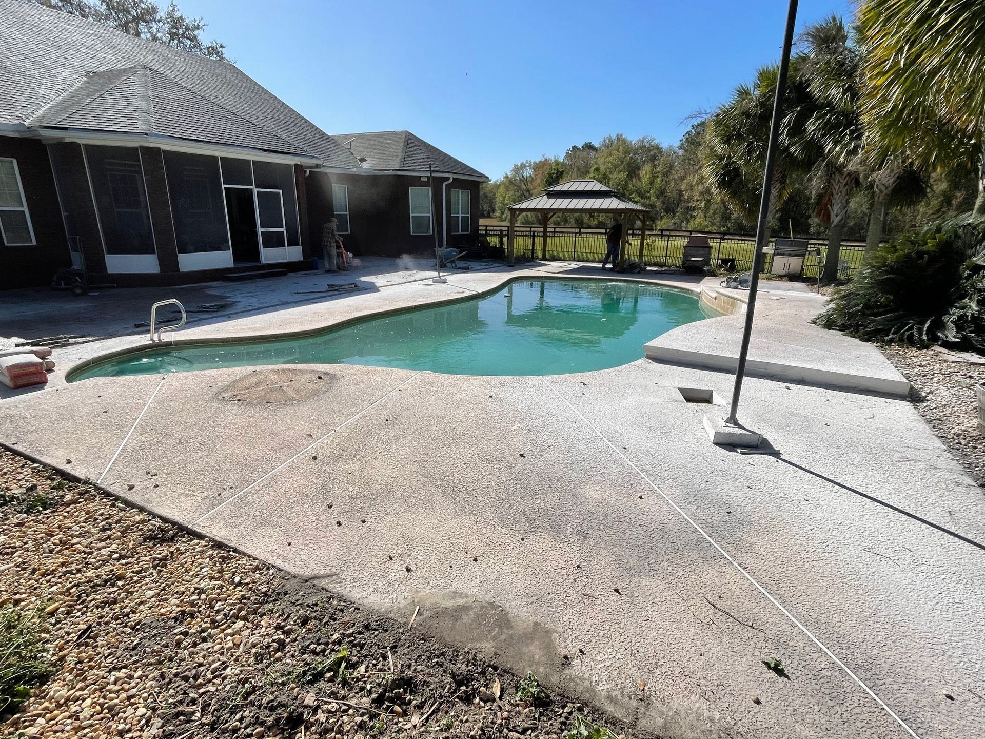 A large swimming pool in the backyard of a house