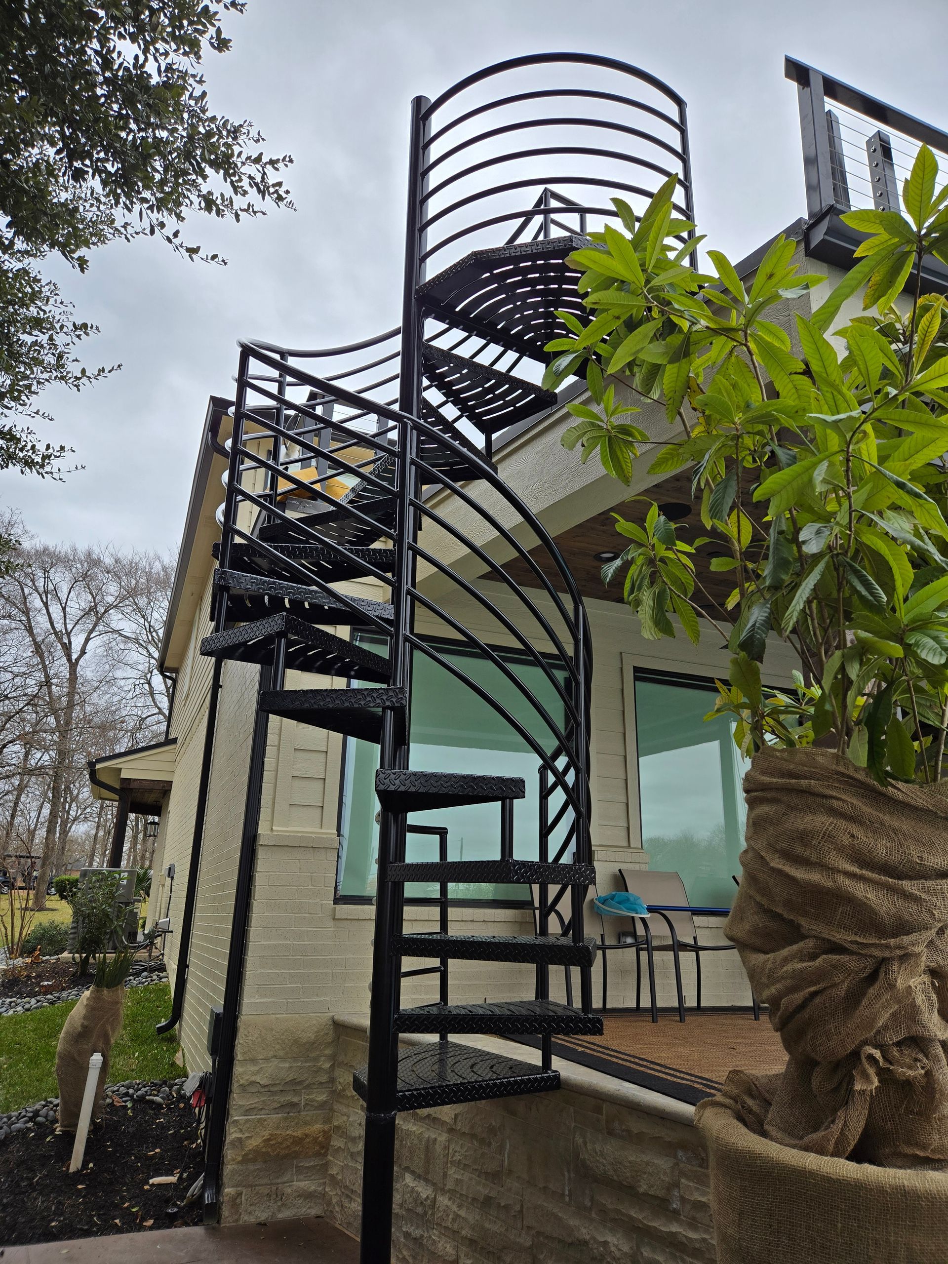 A spiral staircase is leading up to the top of a building.