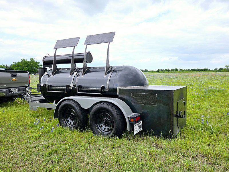 A patio with stainless steel cabinets and a blue and white striped blanket