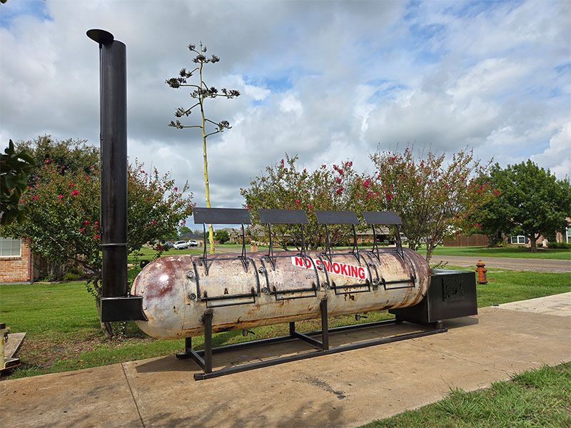 A room with a painting on the wall and a light hanging from the ceiling