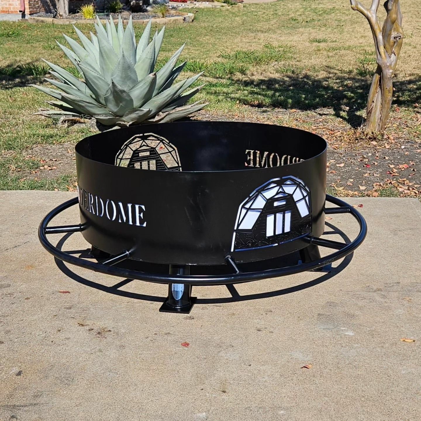 A black fire pit with the word dome on it
